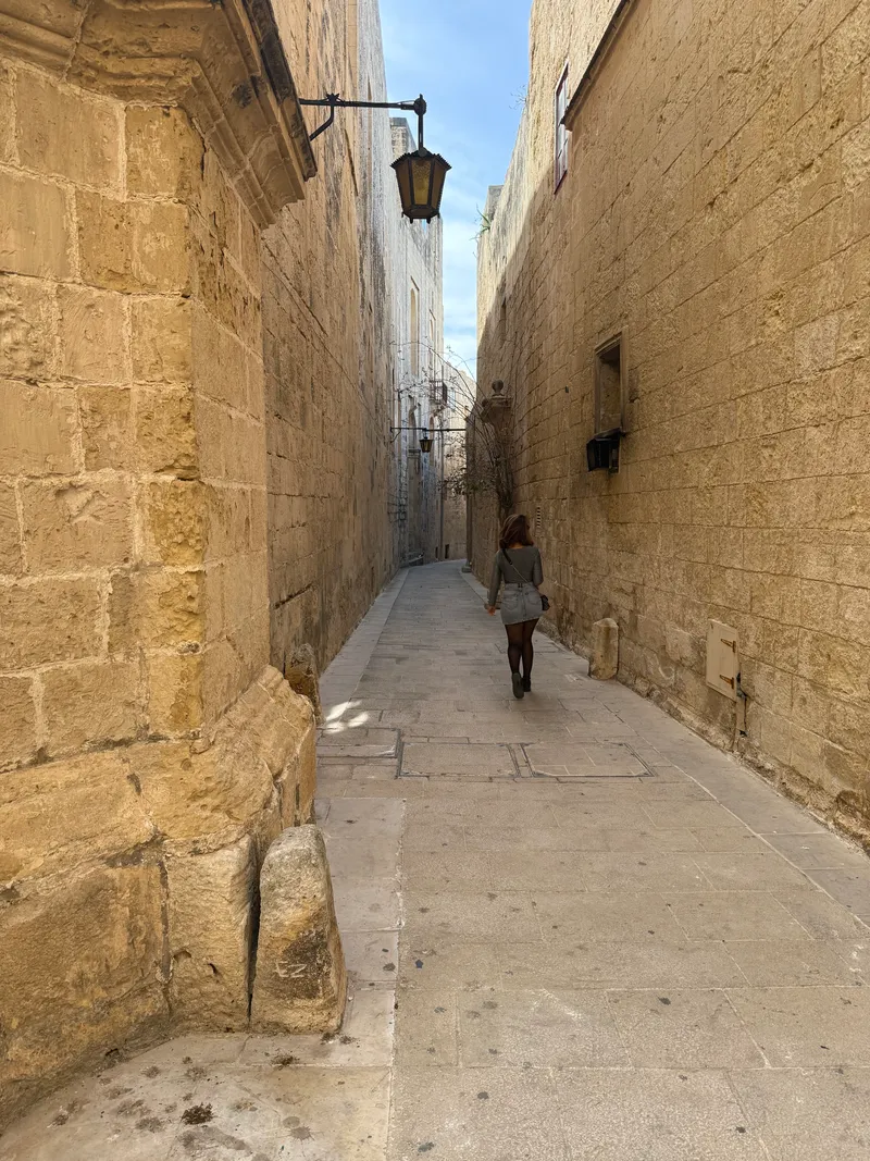 Triq Villegaignon, the spine of Mdina, on a quiet spring afternoon. The honey-limestone walls and the silence the city is named for