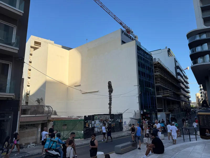Some of that texture: a crane over a stripped building at the edge of Paceville, photographed on an ordinary Saturday